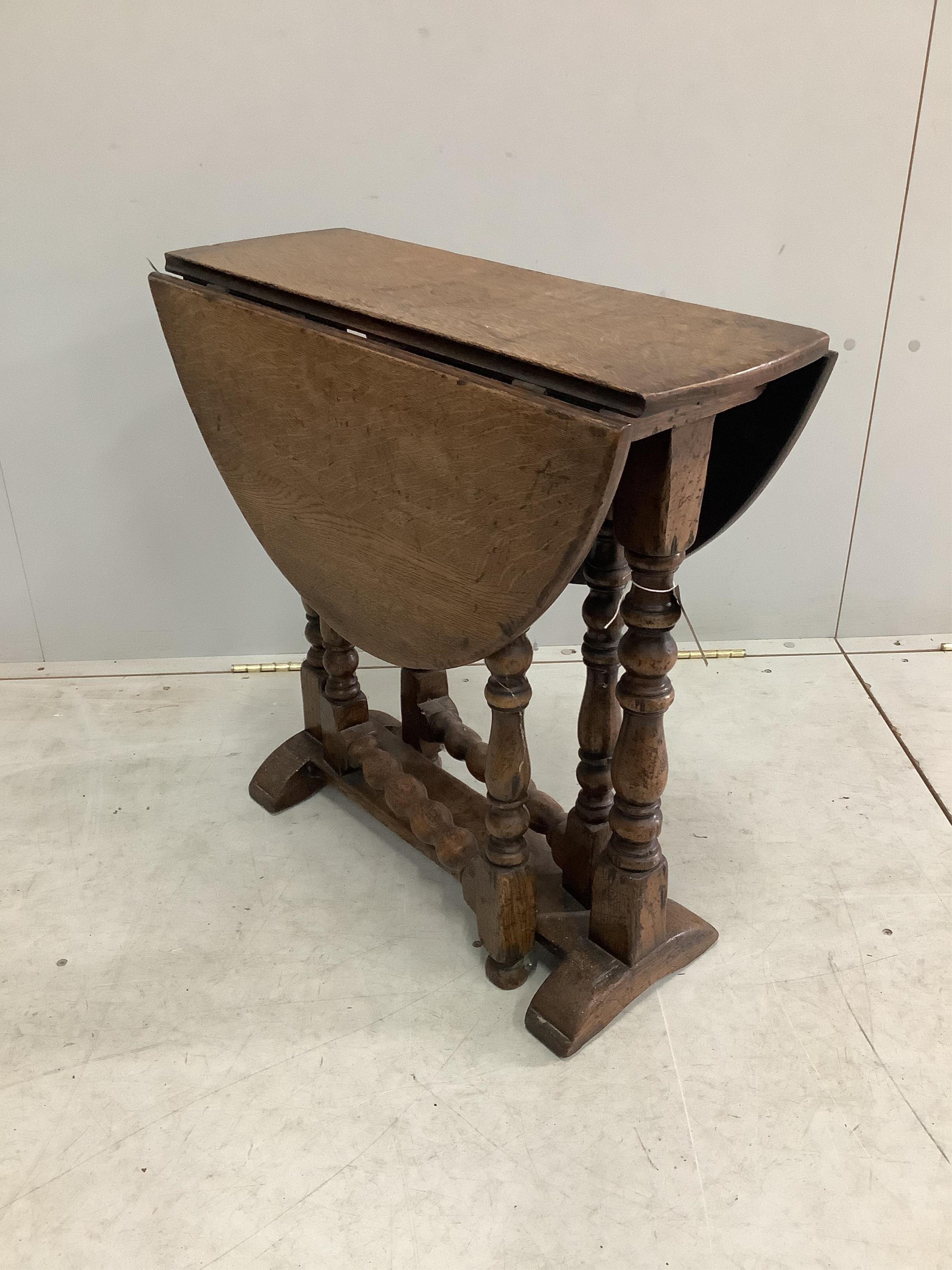 A small 17th century style oak gateleg occasional table, width 65cm, depth 26cm, height 65cm. Condition - fair to good